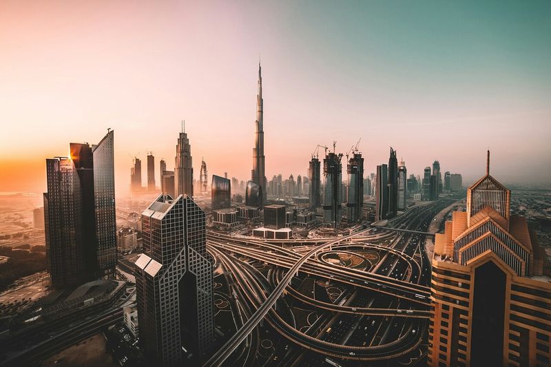 Dubai skyline and a highway interchange at sunset